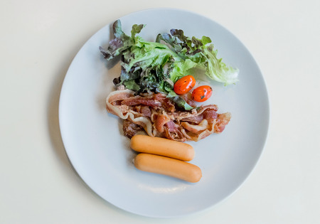 Breakfast sausage with tomato vegetable on white background.の写真素材