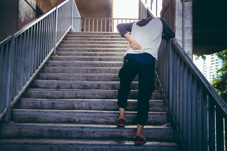 Back view of young man having backache after runner. Sport injury.の写真素材