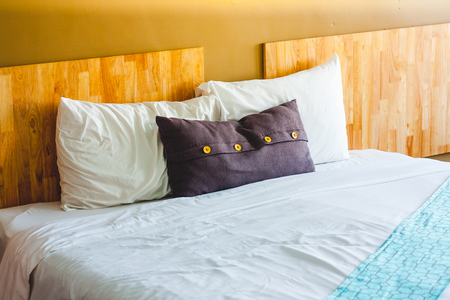Three pillow on bed decoration in vintage  bedroom interior. Bed pillow.の写真素材