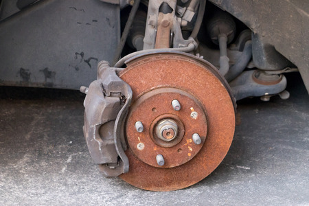 The close up old brake disk and detail of the wheel assemblyの写真素材