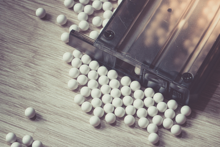 Ammunition with BB metallic balls and magazine on wood background.の写真素材