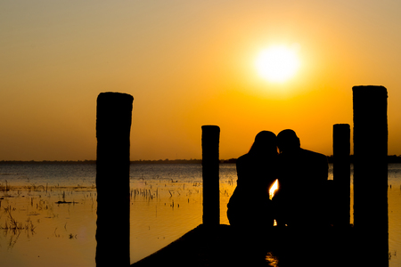 The dream honeymoon in Thailand. The romantic couple silhouette in lake buriram.の写真素材