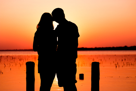The dream honeymoon in Thailand. The romantic couple silhouette in lake buriram.の写真素材