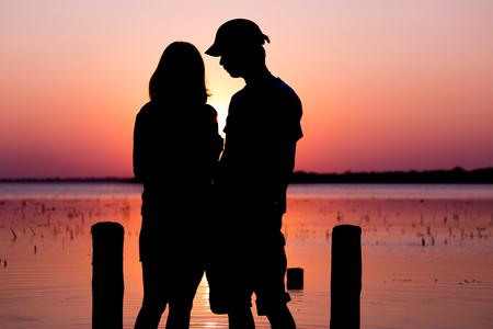 The dream honeymoon in Thailand. The romantic couple silhouette in lake buriram.の写真素材