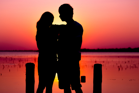 The dream honeymoon in Thailand. The romantic couple silhouette in lake buriram.の写真素材