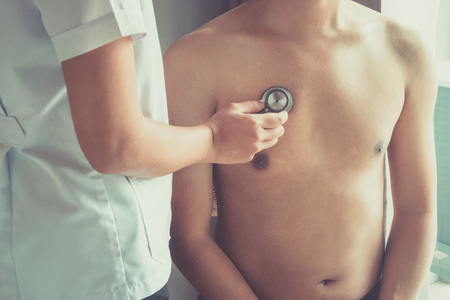 Doctor examining patient with stethoscope in hospital. Medical examination, stethoscope, medicine and therapy.の写真素材