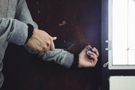 Cloes up dangerous burglar in action of attacking with knife on the house. concept criminal.