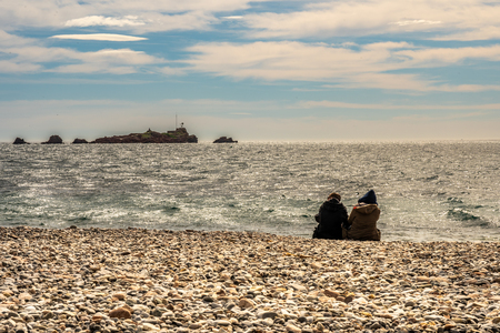 people watching waves of mediterranean sea at french riviera in saint raphael, franceの写真素材