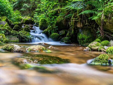 long exposure shot of a tiny waterfall in black forest, germanyの写真素材