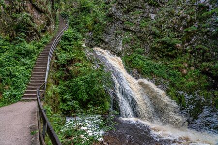 waterfall with bridge at Allerheiligen waterfall cascade in black forest, germanyの写真素材