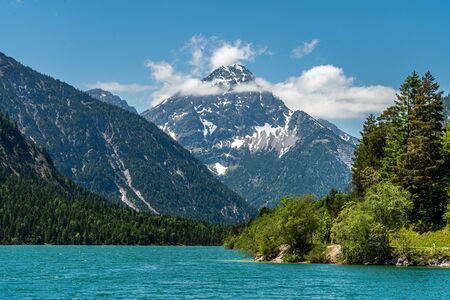 view on lake plansee and tauern in austrian alps, tyrol, austriaの写真素材