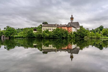 hoeglwoerth abbey and its reflection in the lake near anger in bavaria, germanyの写真素材