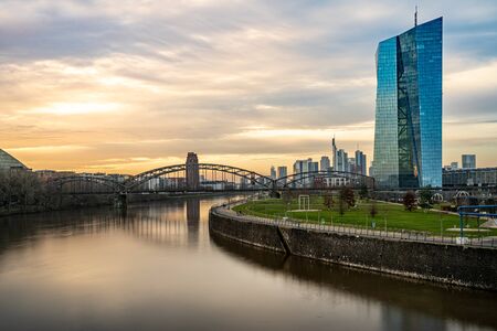 view on frankfurt skyline at sunset from east harbor bridge with reflections in the main river, frankfurt am main, germanyの写真素材