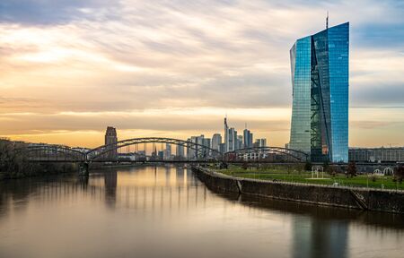 view on frankfurt skyline at sunset from east harbor bridge with reflections in the main river, frankfurt am main, germanyの写真素材