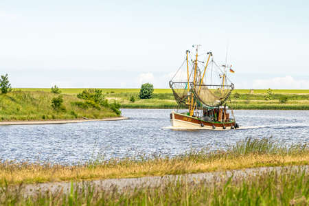 fishing boats returning from their tour to bernersiel, north sea, germanyの写真素材