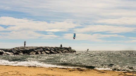 people watching a kite surfer in actionon french riviera in saint raphael, franceの写真素材