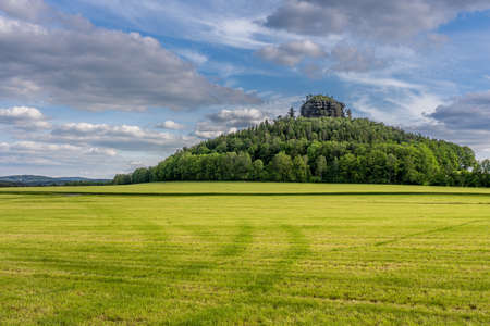 view on the sandstone hill kaiserkrone in saxon switzerland at sunset, germanyの写真素材