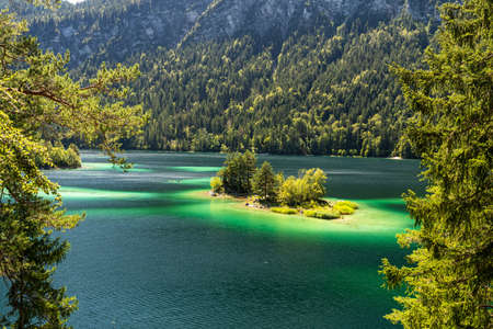View on beautiful island in the eibsee in front of the zugspitze mountain, bavaria, germanyの写真素材