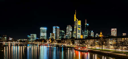 frankfurt skyline at night with colorful reflections in the main river, frankfurt am main, germanyのeditorial素材