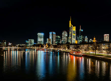 frankfurt skyline at night with colorful reflections in the main river, frankfurt am main, germanyのeditorial素材