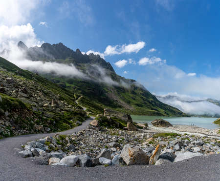 hiking at bieler hoehe, silvretta lake on the high alpine road in montafon austrian alps, austriaの写真素材