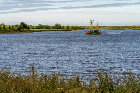 fishing boats returning from their tour to bernersiel, north sea, germanyの写真素材