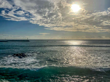 sun with clouds arranged in pattern on mauritius island indian oceanの写真素材