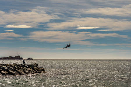 people watching a kite surfer in actionon french riviera in saint raphael, franceの写真素材
