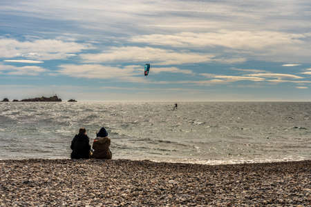 people watching a kite surfer in actionon french riviera in saint raphael, franceの写真素材