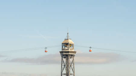 historic cable car cabins approaching the steel towers, harbor and city panorama of Barcelona, spainの写真素材