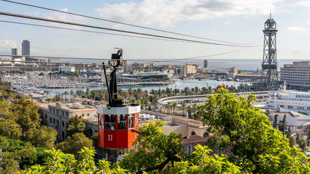 view on historic red cable car cabin and steel tower at the harbor of Barcelona, spainの写真素材