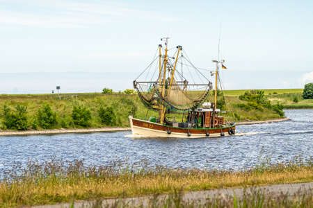 fishing boats returning from their tour to bernersiel, north sea, germanyの写真素材