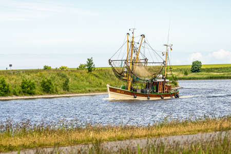fishing boats returning from their tour to bernersiel, north sea, germanyの写真素材