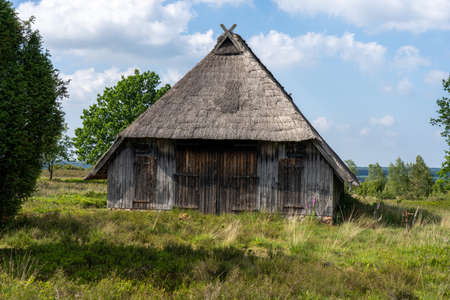 Characteristic stable for German moorland sheep with a straw roof in the natural preserve Lueneburger Heide, Germanyの写真素材