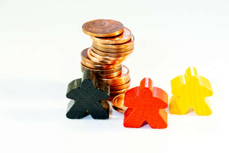 investment concept, color figures on a white background with pile of coinsの写真素材