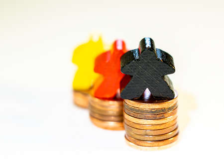 illustration of compentition in financial market with wooden figurines and coinsの写真素材
