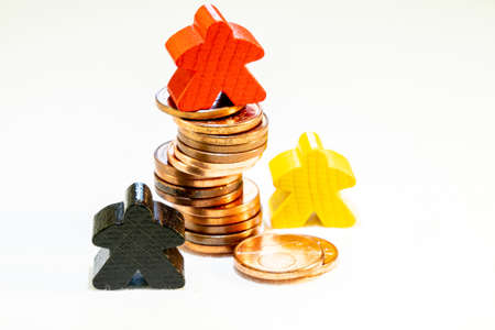 illustration of Financial success with wooden game figures and coinsの写真素材