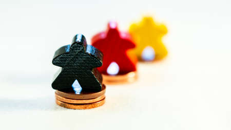 success story of a company in germany shown with wood figurines and coinsの写真素材