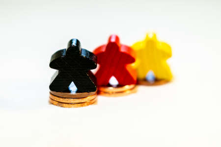 illustration of Financial success with wooden game figures and coinsの写真素材