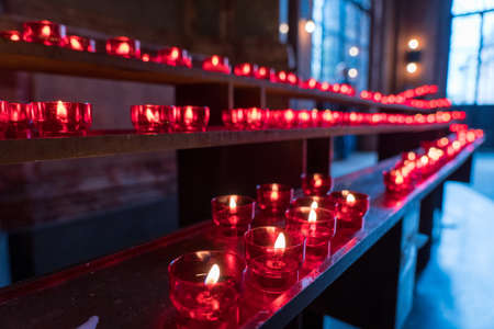 closeup of red candles in Frankfurt dom church, Germanyの写真素材