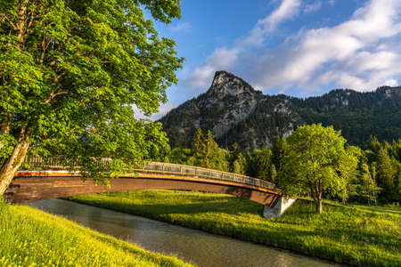 bridge at sunset at the ammer river bank in Oberammergau, Germanyの写真素材