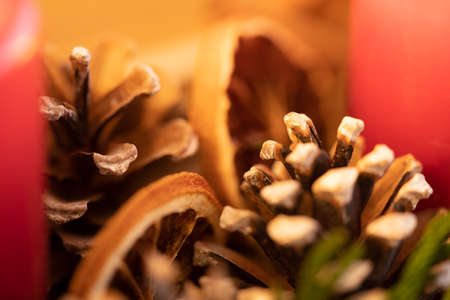 Close up of an advent wreath with pine cones, dried orange slices and candlesの写真素材