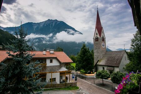 Ancient church in a mountain scenery in South Tyrolの写真素材