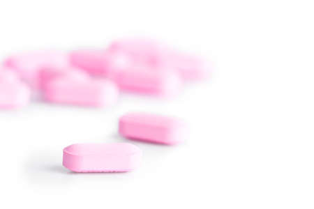 Pink pills isolated on whiteの写真素材