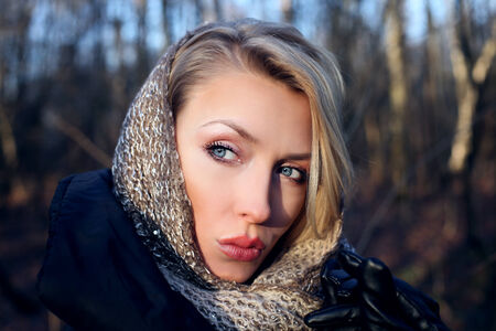 Portrait of beautiful blonde girl looking away. Outdoors photo.の写真素材