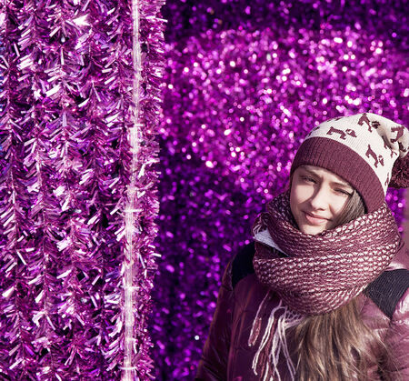 Young beautiful girl, teenager, posing in winter fashionable clothes. Colored background.の写真素材