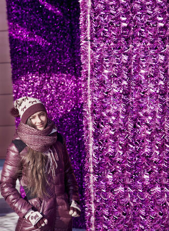 Young beautiful girl, teenager, posing in winter fashionable clothes. Colored background.の写真素材