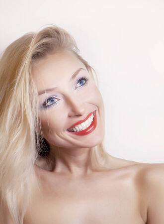 Happy smiling blonde young woman. Beauty portrait photo.の写真素材