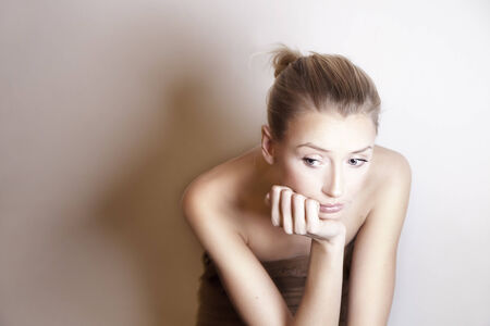 Portrait of beautiful young sad woman. Studio shot.の写真素材