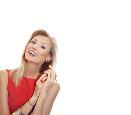 Cheerful blonde beautiful woman posing with toothy smile, looking at camera. Girl isolated on white background. Studio shot.の写真素材